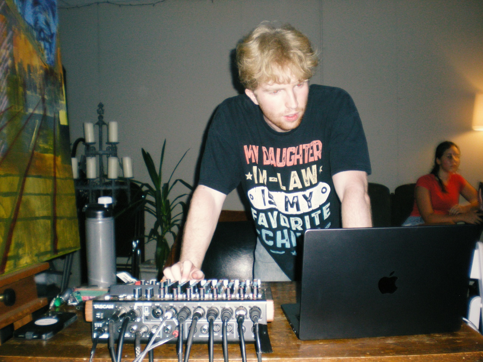 Benjamin Goodman running a Tascam mixer at a live show.